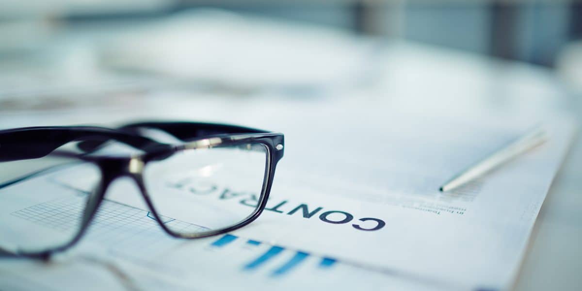 Business consultation with glasses on documents for franchise growth.